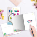 Load image into Gallery viewer, The inside of Tree-Free’s Follow Dreams card, with the cover and envelope in the background.