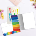 Load image into Gallery viewer, The inside of Tree-Free’s Cumpleanos Rainbow card, with the cover and envelope in the background.