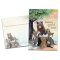 Load image into Gallery viewer, Cover of Sweetest When Shared Birthday card (featuring serif text next to artwork of various animals sitting around a tree stump with a cake on top) and its matching envelope