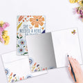 Load image into Gallery viewer, The inside of Tree-Free’s What She Became card, with the cover and envelope in the background.