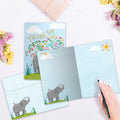 Load image into Gallery viewer, The inside of Tree-Free’s Elephant Flowers card, with the cover and envelope in the background.