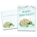 Load image into Gallery viewer, Cover of Flower Turtle Birthday card (featuring serif text above artwork of a turtle with a floral print shell wearing a party hat) and its matching envelope