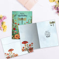 Load image into Gallery viewer, The inside of Tree-Free’s Dragonfly Toadstool card, with the cover and envelope in the background.