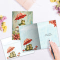 Load image into Gallery viewer, The inside of Tree-Free’s Brighter Frog card, with the cover and envelope in the background.