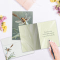 Load image into Gallery viewer, The inside of Tree-Free’s Dragonfly Sympathy Card card, with the cover and envelope in the background.