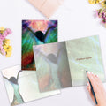 Load image into Gallery viewer, The inside of Tree-Free’s Miracles Happen Encouragement Card card, with the cover and envelope in the background.