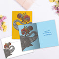 Load image into Gallery viewer, The inside of Tree-Free’s Bursting With Joy card, with the cover and envelope in the background.