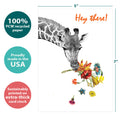 Load image into Gallery viewer, The cover of Tree-Free’s Checking In Giraffe Support Card card with lines demonstrating its 5x7 dimensions, along with the following text: “100% PCW recycled paper, proudly made in the USA, sustainably printed on extra-thick card stock”