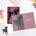 Load image into Gallery viewer, The inside of Tree-Free’s You Me Dogs card, with the cover and envelope in the background.