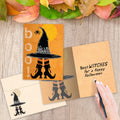 Load image into Gallery viewer, The inside of Tree-Free’s Witch Way Halloween Card card, with the cover and envelope in the background.