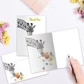 Load image into Gallery viewer, The inside of Tree-Free’s Floral Giraffe Thanks card, with the cover and envelope in the background.