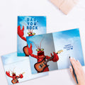 Load image into Gallery viewer, The inside of Tree-Free’s Dad Rocks card, with the cover and envelope in the background.
