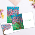 Load image into Gallery viewer, The inside of Tree-Free’s Balloon Tree card, with the cover and envelope in the background.