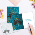 Load image into Gallery viewer, The inside of Tree-Free’s Sea Turtle Pals card, with the cover and envelope in the background.