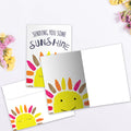 Load image into Gallery viewer, The inside of Tree-Free’s Sending Sunshine card, with the cover and envelope in the background.