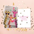 Load image into Gallery viewer, The inside of Tree-Free’s Proud Giraffes card, with the cover and envelope in the background.