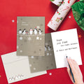 Load image into Gallery viewer, The inside of Tree-Free’s Balancing Penguins Christmas Card card, with the cover and envelope in the background.
