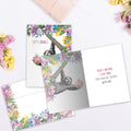 Load image into Gallery viewer, The inside of Tree-Free’s Felicidades Hearts card, with the cover and envelope in the background.