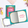 Load image into Gallery viewer, The inside of Tree-Free’s Lying About It card, with the cover and envelope in the background.