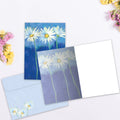 Load image into Gallery viewer, The inside of Tree-Free’s Daisies On Blue All Occasion Card card, with the cover and envelope in the background.