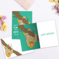 Load image into Gallery viewer, The inside of Tree-Free’s Slow Sloth Birthday card, with the cover and envelope in the background.