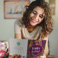Load image into Gallery viewer, Lifestyle image(s) featuring Tree-Free’s Purple Flower Birthday card