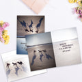 Load image into Gallery viewer, The inside of Tree-Free’s New Perspective card, with the cover and envelope in the background.