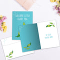 Load image into Gallery viewer, The inside of Tree-Free’s Welcome Sweet Pea card, with the cover and envelope in the background.