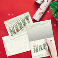 Load image into Gallery viewer, The inside of Tree-Free’s Merry Little Christmas Drawn Christmas Card card, with the cover and envelope in the background.