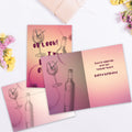 Load image into Gallery viewer, The inside of Tree-Free’s Wine O'Clock card, with the cover and envelope in the background.