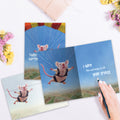 Load image into Gallery viewer, The inside of Tree-Free’s Chute Happens card, with the cover and envelope in the background.