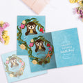 Load image into Gallery viewer, The inside of Tree-Free’s Sea Of Happy card, with the cover and envelope in the background.