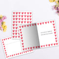 Load image into Gallery viewer, The inside of Tree-Free’s Watercolor Hearts card, with the cover and envelope in the background.