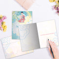 Load image into Gallery viewer, The inside of Tree-Free’s Let It Go card, with the cover and envelope in the background.
