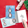Load image into Gallery viewer, The inside of Tree-Free’s Boho Christmas Penguins card, with the cover and envelope in the background.