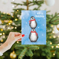 Load image into Gallery viewer, Lifestyle image(s) featuring Tree-Free's Boho Christmas Penguins Holiday Card card