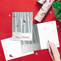 Load image into Gallery viewer, The inside of Tree-Free’s Christmas Cardinals Holiday Card card, with the cover and envelope in the background.
