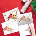 Load image into Gallery viewer, The inside of Tree-Free’s Peace Birds card, with the cover and envelope in the background.