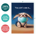 Load image into Gallery viewer, The cover of Tree-Free’s Mask Bunny card with lines demonstrating its 5x7 dimensions, along with the following text: “100% PCW recycled paper, proudly made in the USA, sustainably printed on extra-thick card stock”