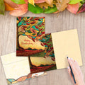 Load image into Gallery viewer, The inside of Tree-Free’s Fall Colors card, with the cover and envelope in the background.