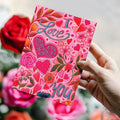 Load image into Gallery viewer, Lifestyle image(s) featuring Tree-Free’s I Love You Floral card