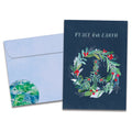 Load image into Gallery viewer, The cover of Tree-Free's Peace On Earth Wreath Holiday Card card, along with its matching envelope.