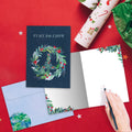 Load image into Gallery viewer, The inside of Tree-Free’s Peace On Earth Wreath card, with the cover and envelope in the background.