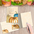 Load image into Gallery viewer, The inside of Tree-Free’s Thankful Pumpkins card, with the cover and envelope in the background.