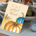 Load image into Gallery viewer, Lifestyle image(s) featuring Tree-Free’s Thankful Pumpkins Thanksgiving Card card
