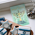 Load image into Gallery viewer, The inside of Tree-Free’s Floral Menorah Hanukkah Card card, with the cover and envelope in the background.