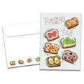 Load image into Gallery viewer, The cover of Tree-Free's Toasting You card, along with its matching envelope.