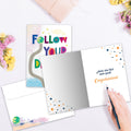 Load image into Gallery viewer, The inside of Tree-Free’s Follow Dreams card, with the cover and envelope in the background.
