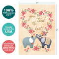 Load image into Gallery viewer, The cover of Tree-Free’s Tied The Knot Elephants card with lines demonstrating its 5x7 dimensions, along with the following text: “100% PCW recycled paper, proudly made in the USA, sustainably printed on extra-thick card stock”