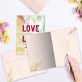 Load image into Gallery viewer, The inside of Tree-Free’s Love Is Love card, with the cover and envelope in the background.